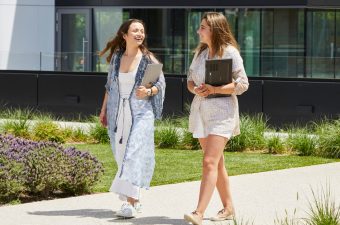 girl students walking in IE Tower|||