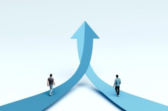 Two,Men,Walking,On,Opposite,Arrow,Paths,Merging,Into,One